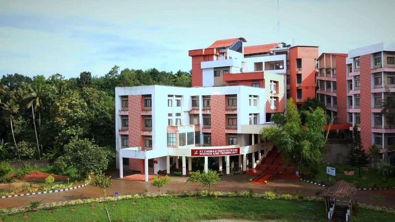 Photo of a college building from top, showing multistoreyed buildings and greenery